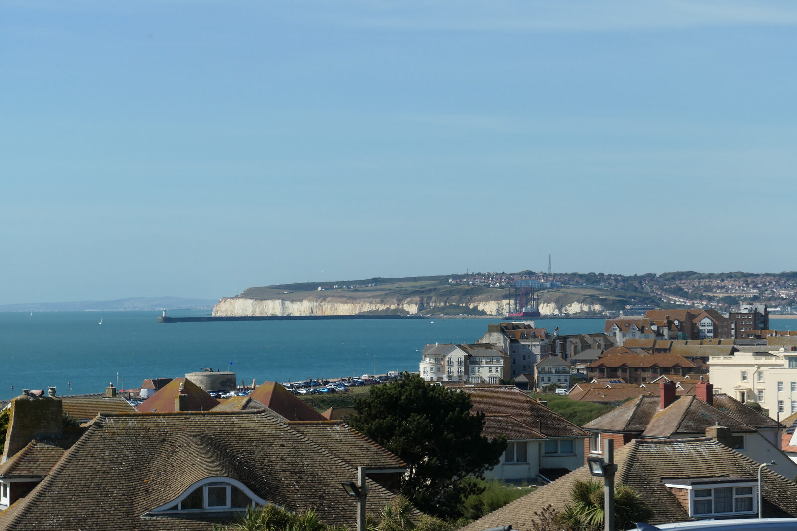 Seaford Bay looking west across the rooftops towards the Martello tower and the Newhaven cliffs